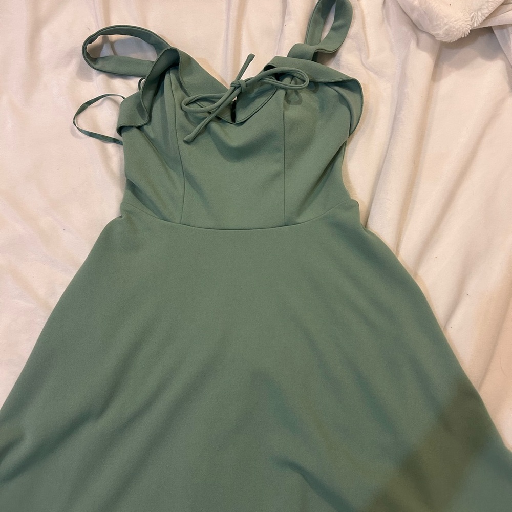 Green mini city studio dress with tie in front